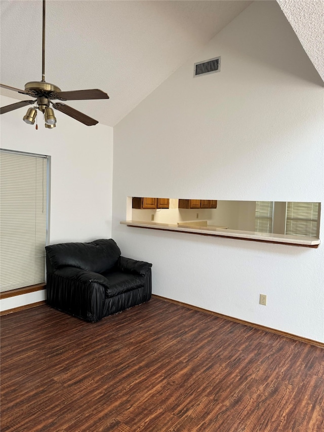 sitting room with a textured ceiling, hardwood / wood-style flooring, ceiling fan, and vaulted ceiling