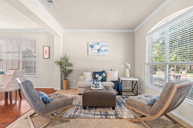 living room featuring crown molding, hardwood / wood-style flooring, and a wealth of natural light