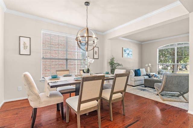 dining space with a notable chandelier, hardwood / wood-style floors, and crown molding