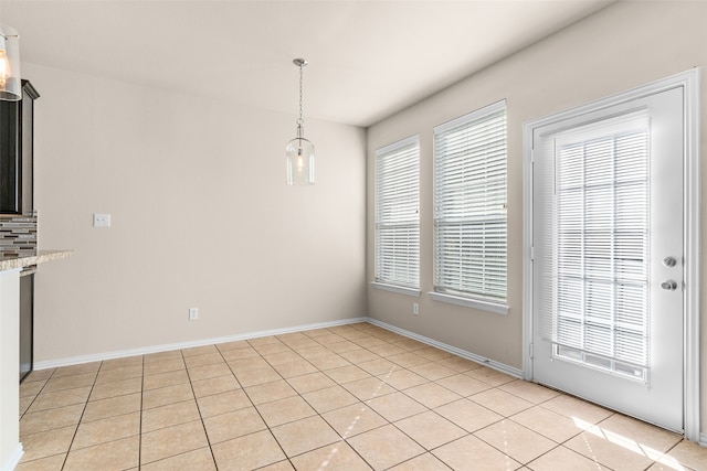 unfurnished dining area with light tile patterned flooring and a wealth of natural light