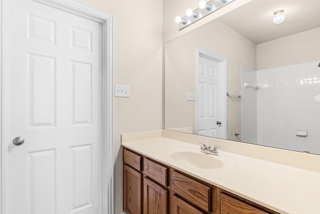 bathroom with vanity and a shower