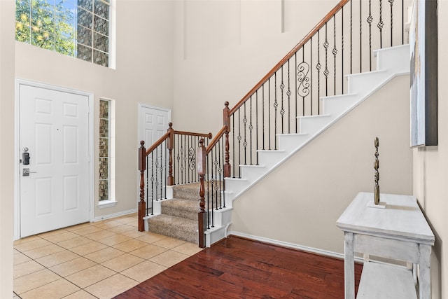 foyer with plenty of natural light, a high ceiling, and light wood-type flooring