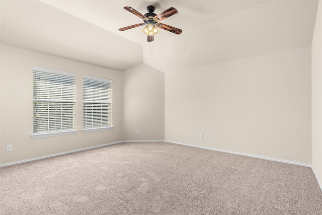 carpeted empty room with ceiling fan and vaulted ceiling