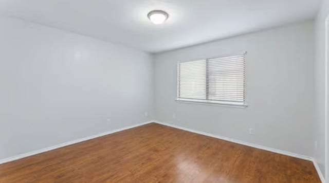 empty room featuring wood-type flooring