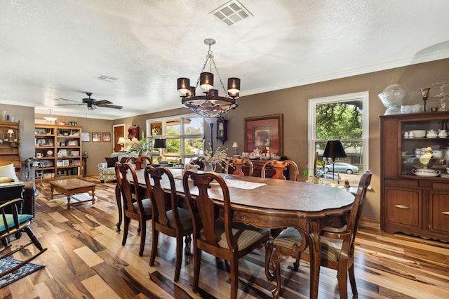 dining space with visible vents, plenty of natural light, and light wood finished floors