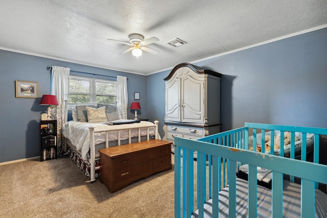bedroom with light colored carpet, a textured ceiling, baseboards, visible vents, and ornamental molding