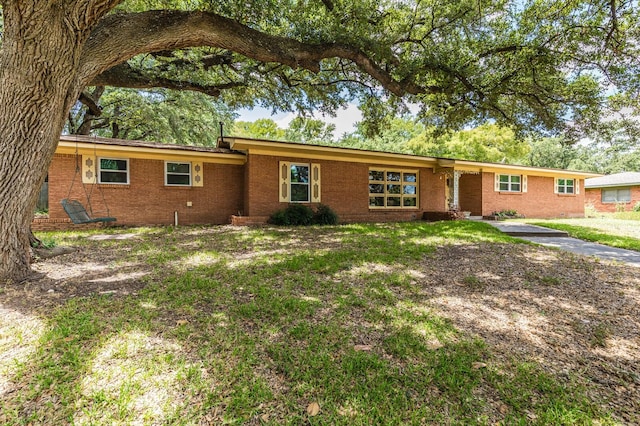 single story home featuring brick siding