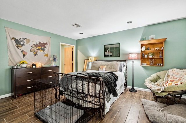 bedroom with baseboards, dark wood-style floors, and visible vents