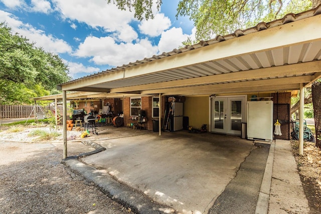 exterior space with a patio area, fence, french doors, and a carport
