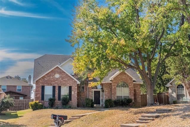 4309 Sarasota Ln, Mckinney, TX 75070 - view of front facade featuring fence, a front lawn, roof with shingles, and brick siding