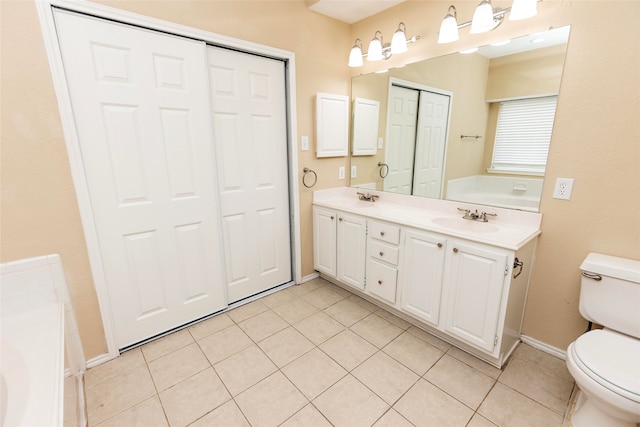 bathroom with vanity, toilet, a tub, and tile patterned flooring