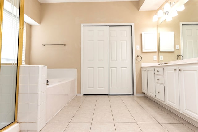 bathroom featuring vanity, independent shower and bath, and tile patterned flooring