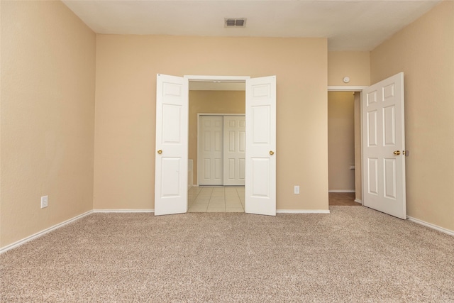 unfurnished bedroom with light colored carpet