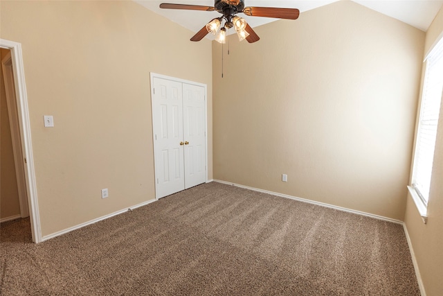 unfurnished bedroom with ceiling fan, carpet, and lofted ceiling