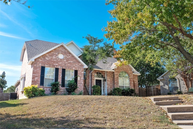4309 Sarasota Ln, Mckinney, TX 75070 - view of front facade with roof with shingles, fence, and brick siding
