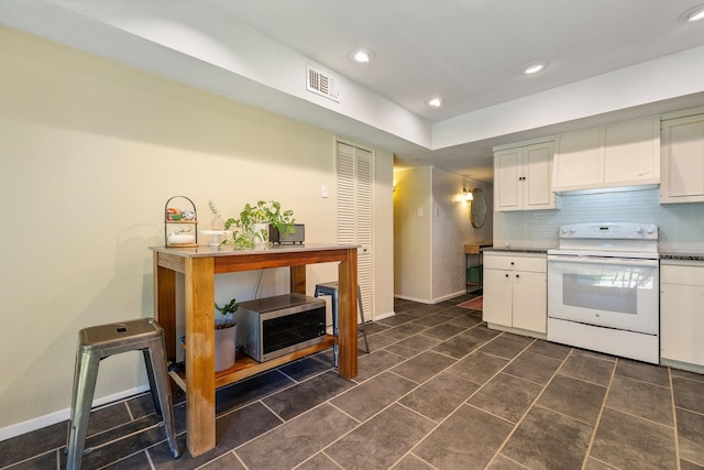 kitchen with decorative backsplash, electric range, and white cabinetry