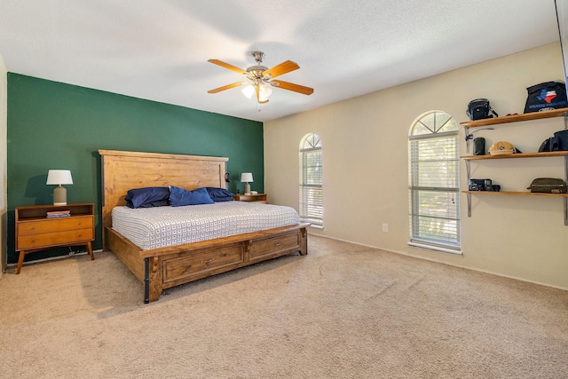 bedroom with ceiling fan and light carpet