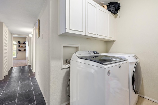 washroom featuring cabinets, washer and dryer, and dark carpet