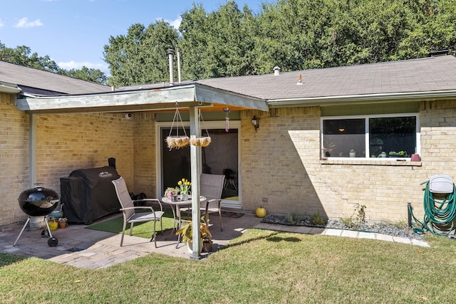 back of house with a patio area and a yard