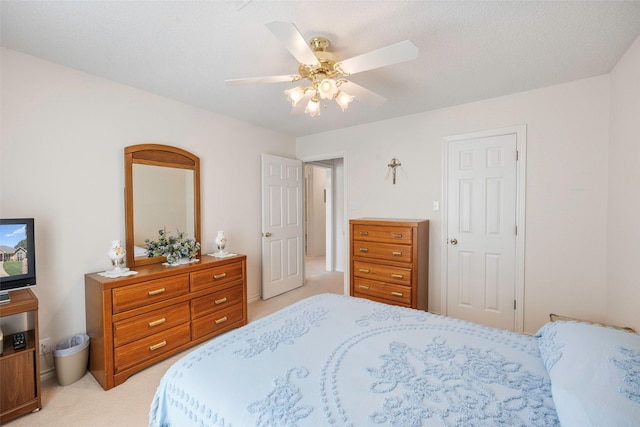 bedroom featuring light carpet and ceiling fan