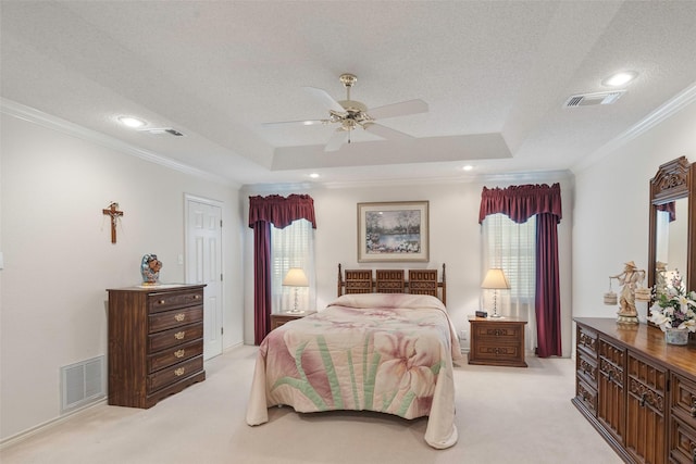 carpeted bedroom with crown molding, a raised ceiling, multiple windows, and a textured ceiling