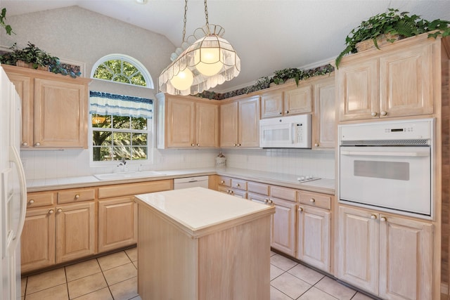 kitchen with sink, hanging light fixtures, a center island, light brown cabinets, and white appliances