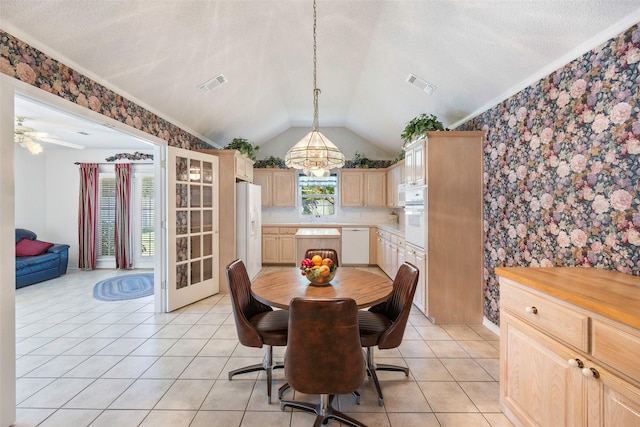 tiled dining area with lofted ceiling and a textured ceiling