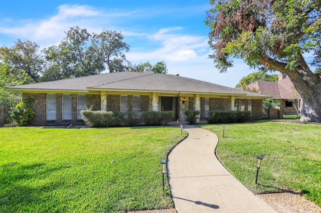 ranch-style home with covered porch and a front lawn