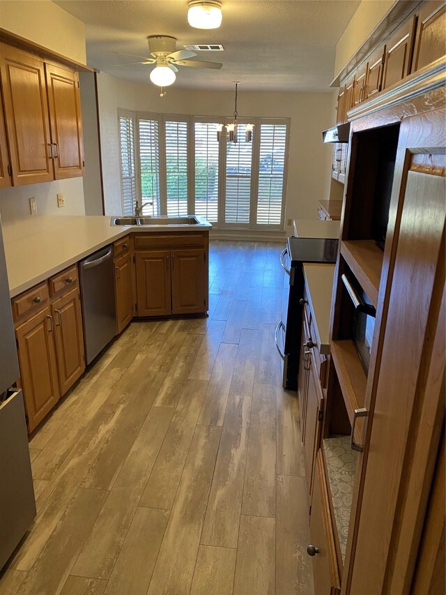 kitchen featuring sink, light hardwood / wood-style flooring, dishwasher, electric range oven, and kitchen peninsula