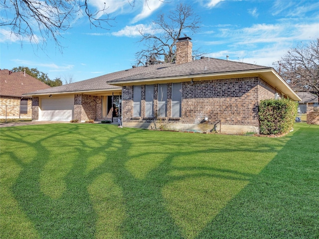 back of property with a garage and a lawn