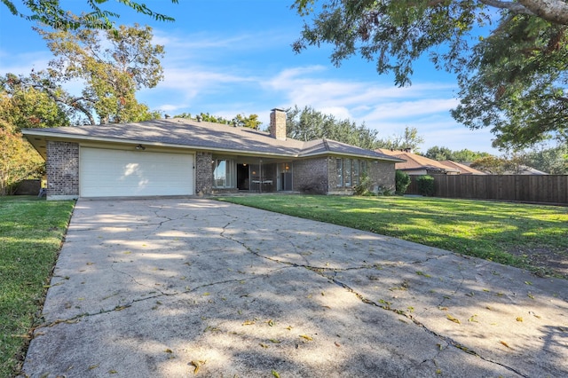 ranch-style home featuring a garage and a front lawn