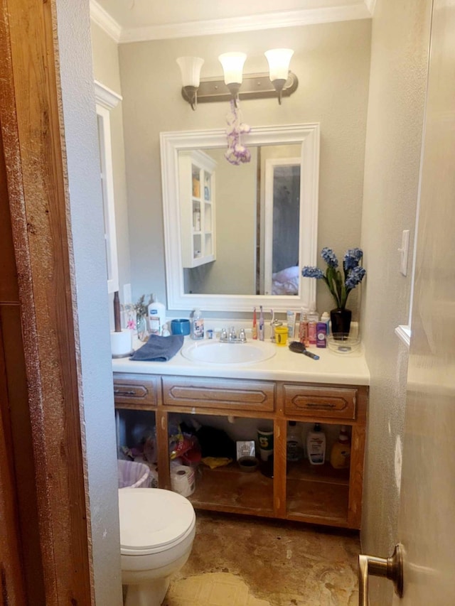 bathroom with vanity, ornamental molding, and toilet