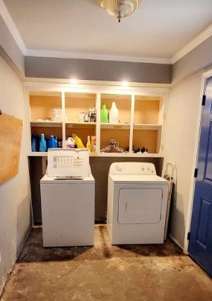 laundry area featuring ornamental molding and washer and clothes dryer