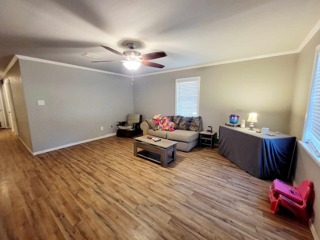 living room with ornamental molding, hardwood / wood-style floors, and ceiling fan