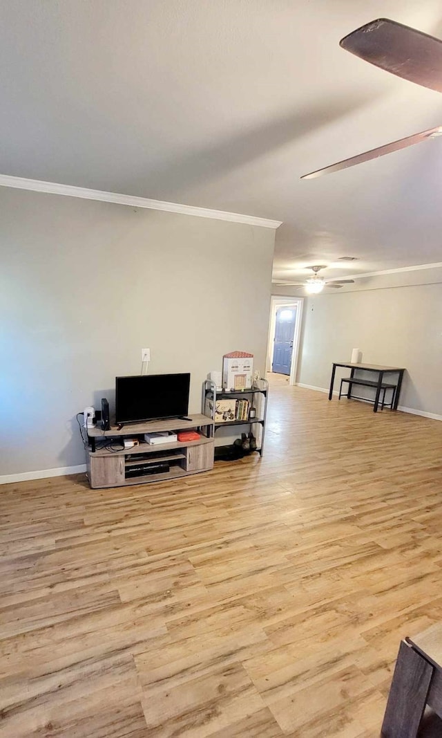 living room with ornamental molding, light hardwood / wood-style floors, and ceiling fan