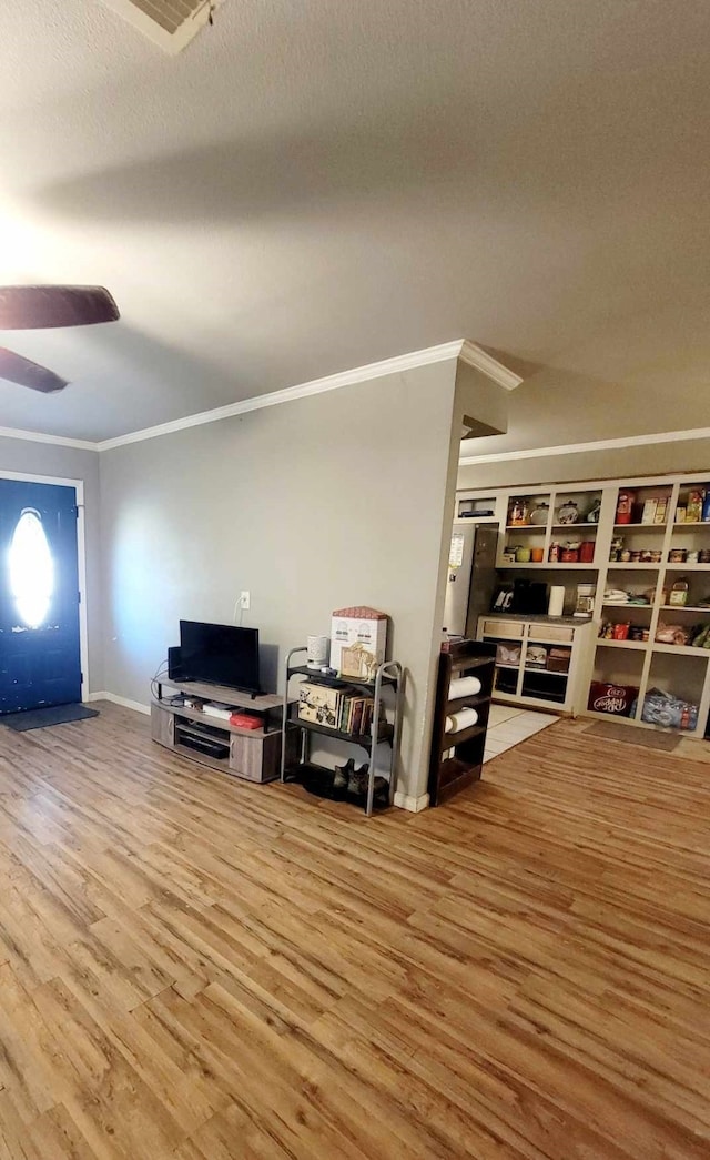 living room featuring ornamental molding, hardwood / wood-style floors, a textured ceiling, and ceiling fan