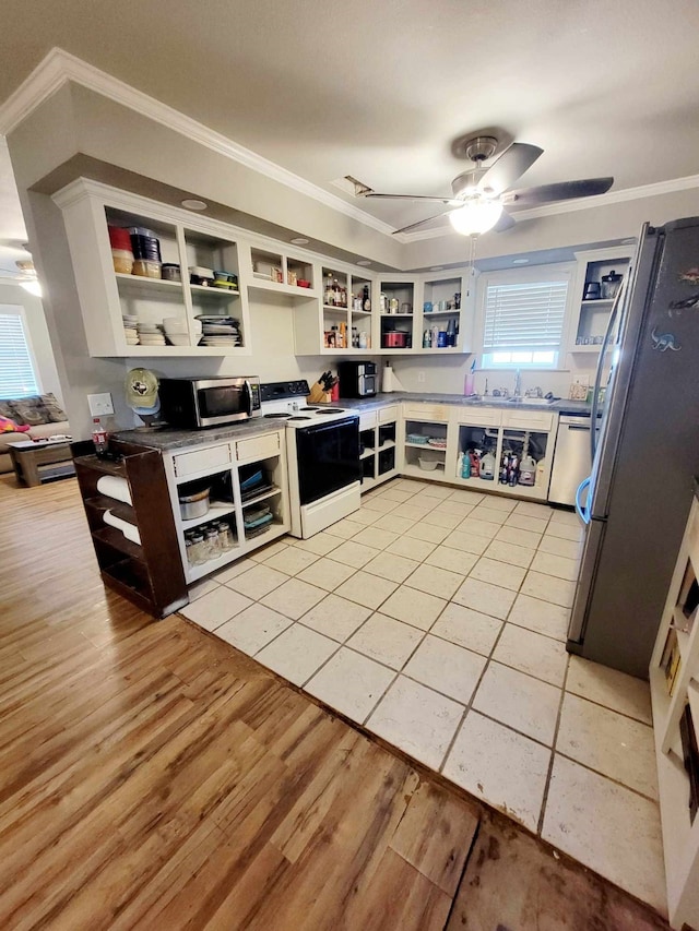 kitchen featuring white cabinetry, stainless steel appliances, ornamental molding, and light wood-type flooring