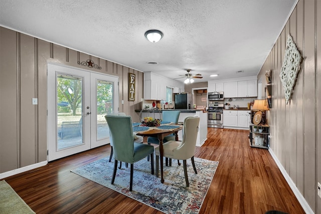 dining room with french doors, wood-type flooring, a textured ceiling, and ceiling fan