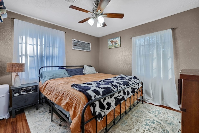 bedroom featuring ceiling fan and wood-type flooring