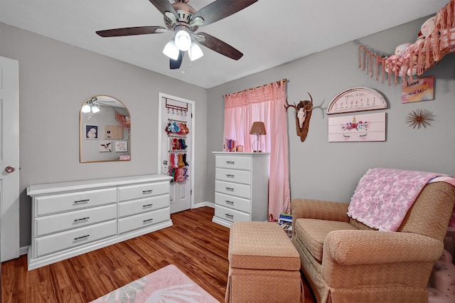 sitting room featuring ceiling fan and wood-type flooring