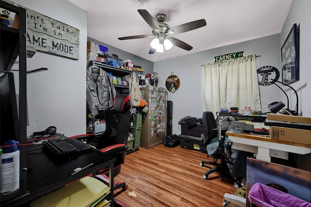 office with hardwood / wood-style floors and ceiling fan