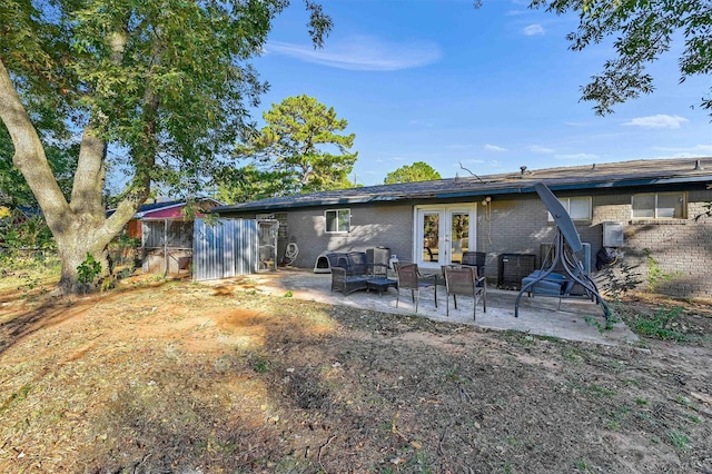 back of property featuring french doors and a patio