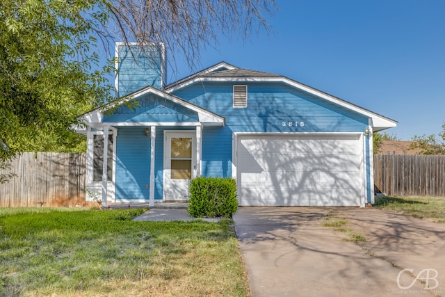 view of front of property with a garage and a front lawn