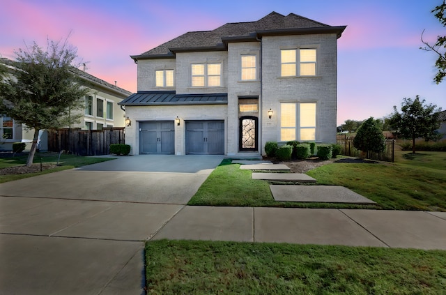 view of front of home featuring a yard and a garage