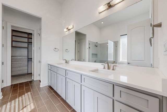 bathroom with vanity and a shower with shower door