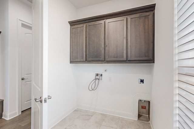 washroom with cabinets, hookup for an electric dryer, hookup for a gas dryer, and hookup for a washing machine