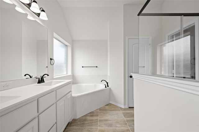 bathroom with tile patterned floors, vanity, separate shower and tub, and lofted ceiling