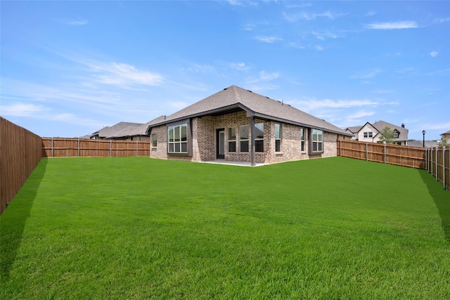 rear view of house with a lawn