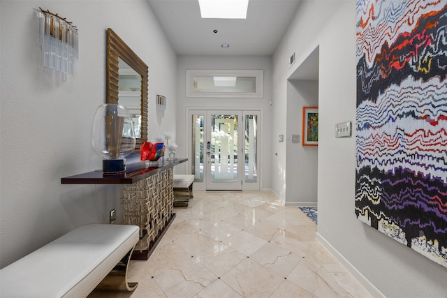 foyer entrance featuring a skylight