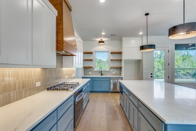 505 Aermotor Loop, Weatherford, TX 76085 - kitchen with appliances with stainless steel finishes, custom exhaust hood, open shelves, white cabinetry, and light wood-style flooring